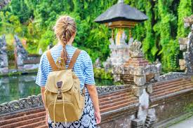 Local market vendor arranging traditional goods for budget travelers